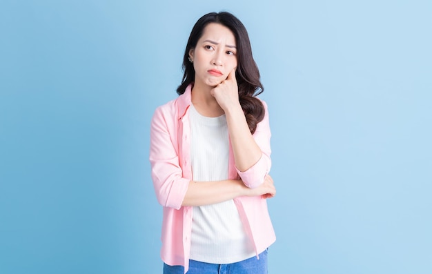 Portrait of young Asian woman on background