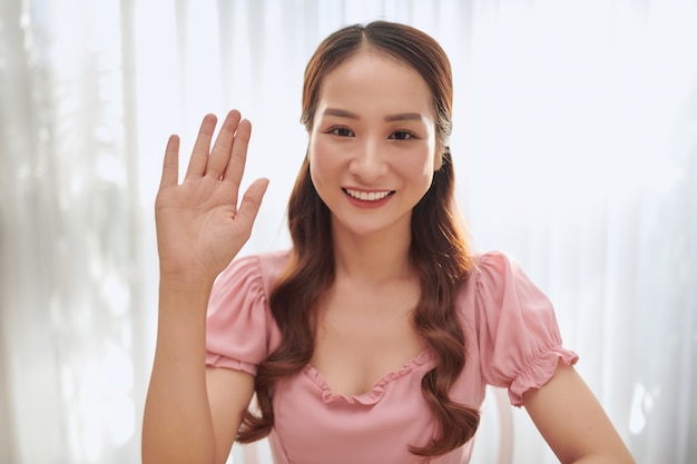 Portrait of young Asian woman blogger at home