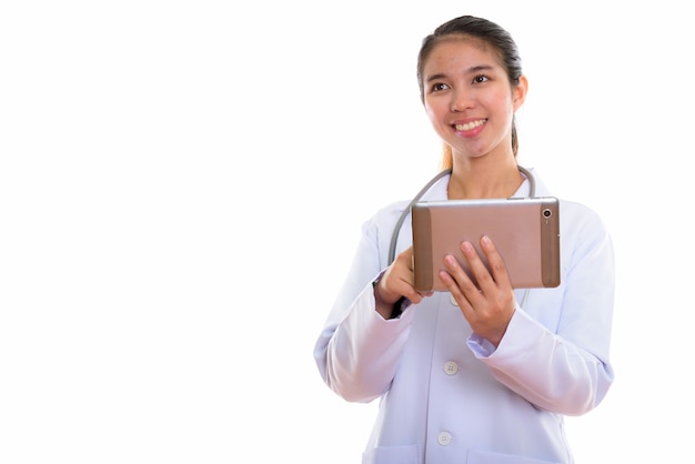 Portrait of young Asian woman doctor using digital tablet