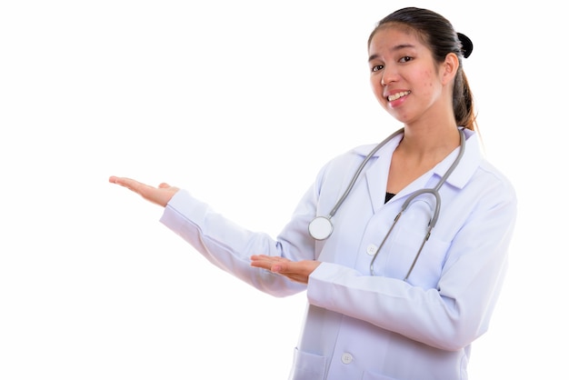 Portrait of young Asian woman doctor on white