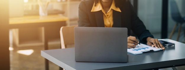 Portrait of Young Asian woman hand freelancer is working her job on computer tablet in modern office Doing accounting analysis report real estate investment data Financial and tax systems concept