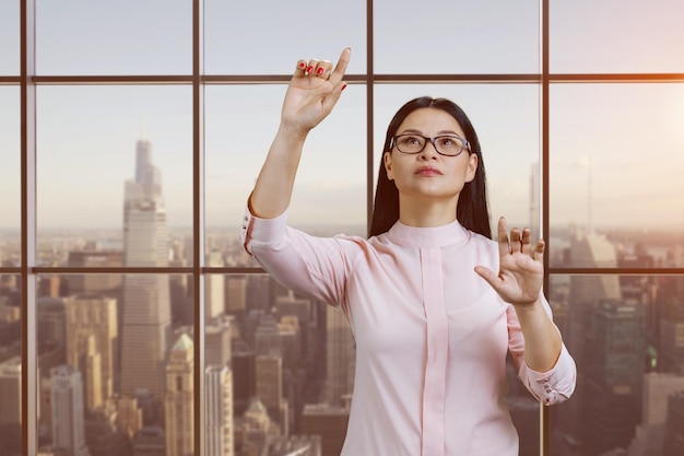 Portrait of young asian woman is interacting with invisible virtual