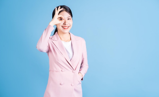 Portrait of young Asian woman posing on background