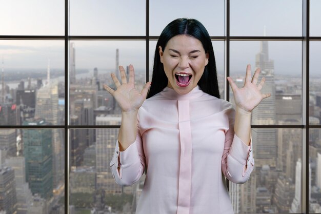 Portrait of young asian woman screaming out loud