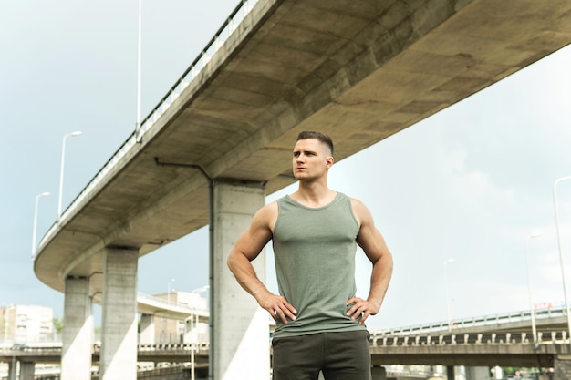 Portrait of young athlete man wearing khaki sportswear after his street workout