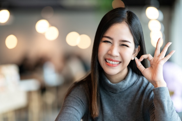 Portrait of young attractive asian woman looking at camera