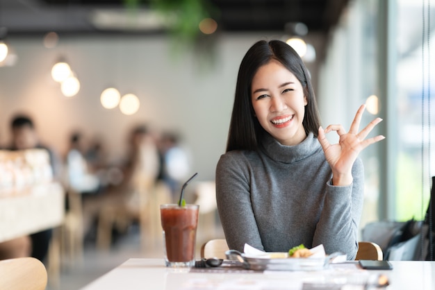 Portrait of young attractive asian woman looking at camera