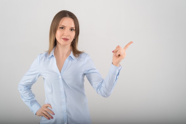 Portrait of young attractive business lady showing on white isolated background