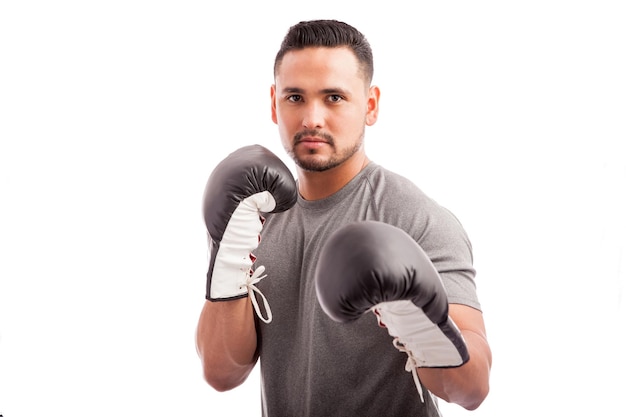 Portrait of a young attractive Hispanic boxer ready for a fight