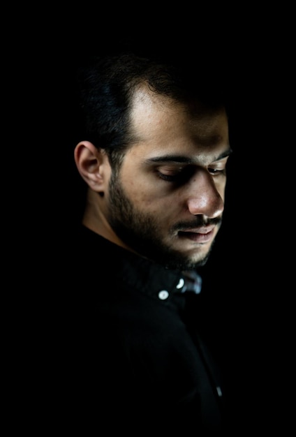 Portrait of young attractive man on a black background high quality photo