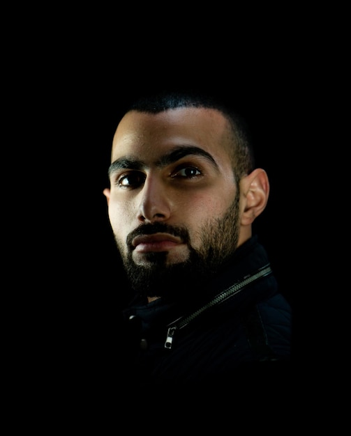 Portrait of young attractive man on a black background. High quality photo