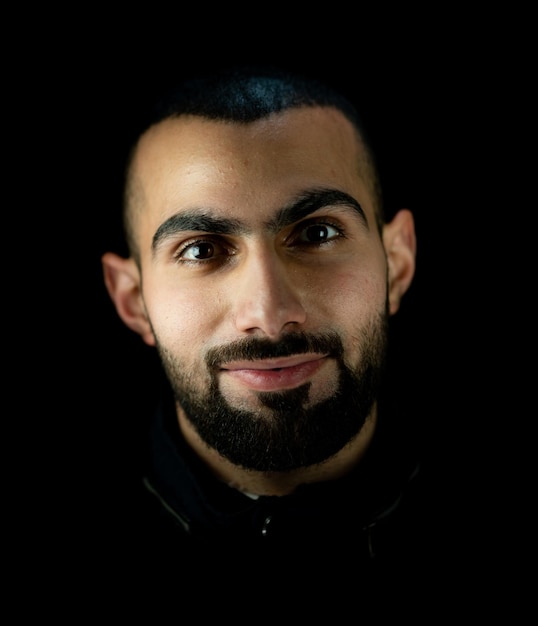 Portrait of young attractive man on a black background. High quality photo