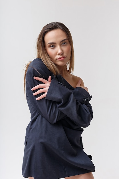 Portrait of young attractive skinny asian woman in blue suit with long hair