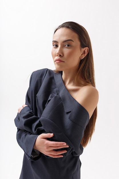 Portrait of young attractive skinny asian woman in blue suit