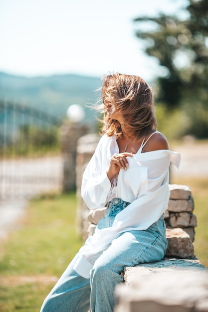 Portrait of young attractive tourist woman outdoors