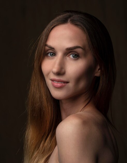 portrait of a young attractive woman on a dark background