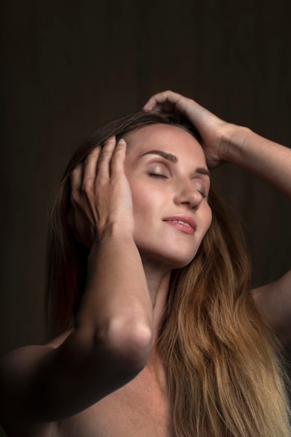 portrait of a young attractive woman on a dark background