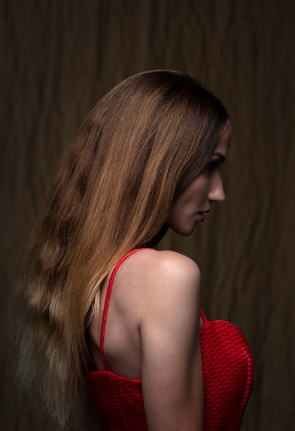 portrait of a young attractive woman on a dark background