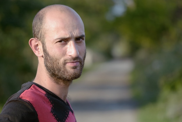 Portrait of a young bearded guy unshaven