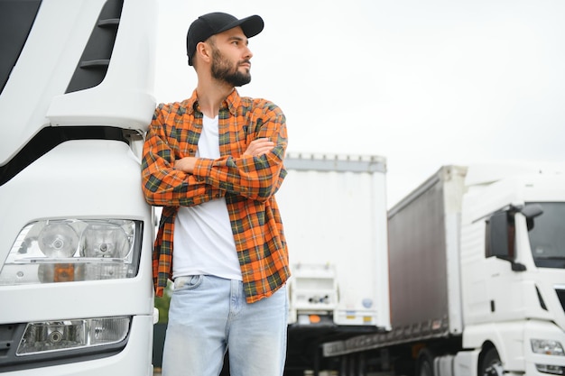 Portrait of young bearded trucker standing by his truck vehicle Transportation service Truck driver job