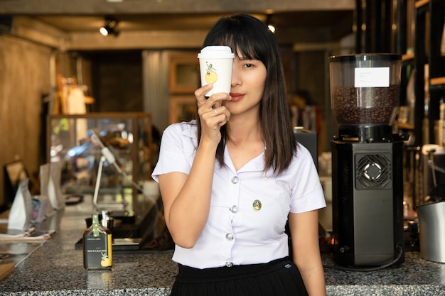 portrait of young beautiful asian school girl at coffee shop