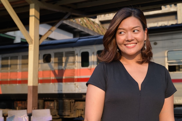 Portrait of young beautiful Asian tourist woman at the Hua Lamphong railway station in Bangkok