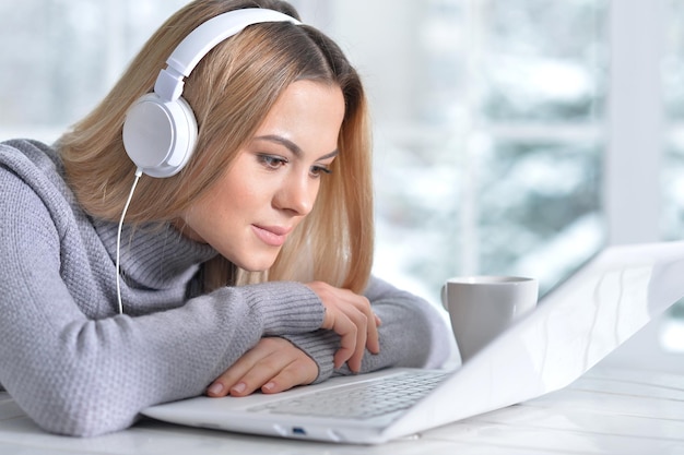 Portrait of a young beautiful blonde woman using laptop