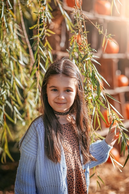 Portrait of a young beautiful brunette little girl outdoor in summer day Closeup portrait of a beaut