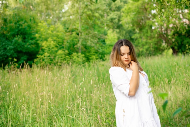 Portrait of a young beautiful brunette in the park