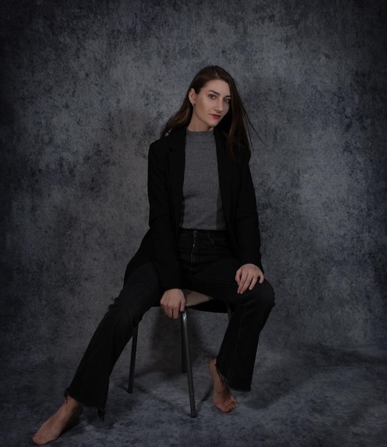 Portrait of young beautiful business-woman on grey background closeup.