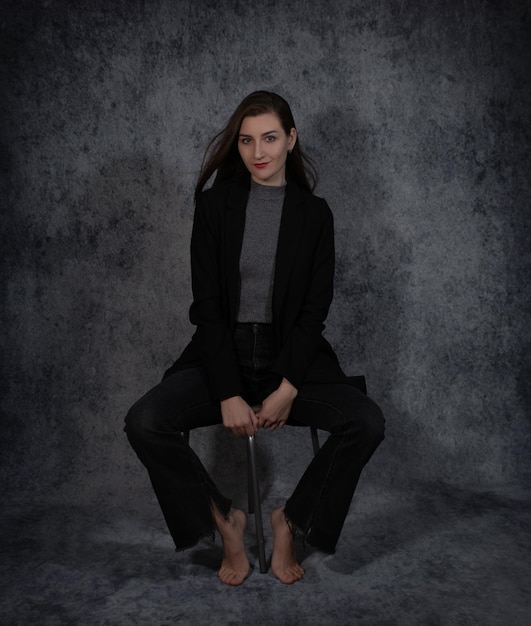 Portrait of young beautiful business-woman on grey background closeup.