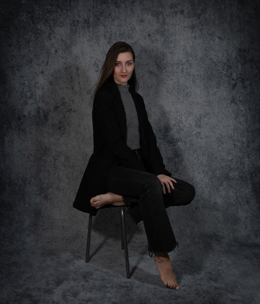 Portrait of young beautiful business-woman on grey background closeup.