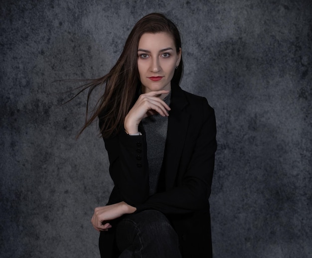 Portrait of young beautiful business-woman on grey background closeup.