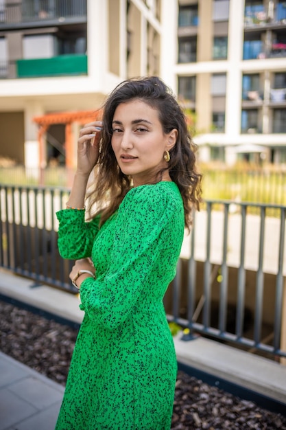 Portrait of young beautiful caucasian brown hair woman posing outdoor in the city