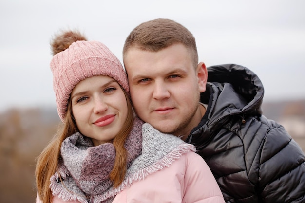 Portrait of a young beautiful couple outdoors, close-up