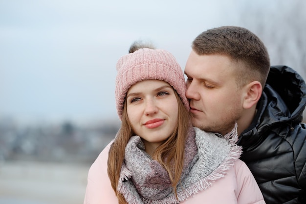 Portrait of a young beautiful couple outdoors, close-up