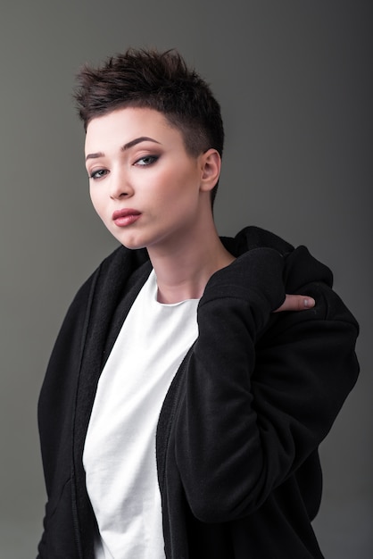 Portrait of a young beautiful girl against a dark background