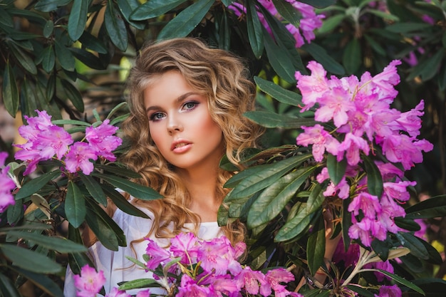 Portrait of a young beautiful girl in flowers.