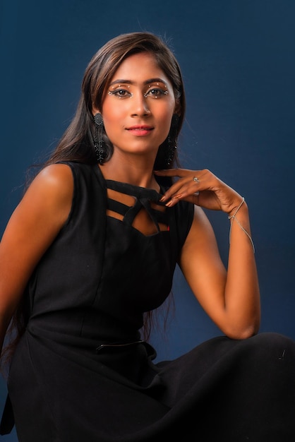 Portrait of a young beautiful girl posing on gray background