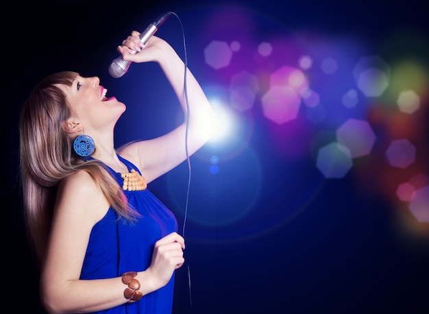 Portrait of young beautiful girl singing