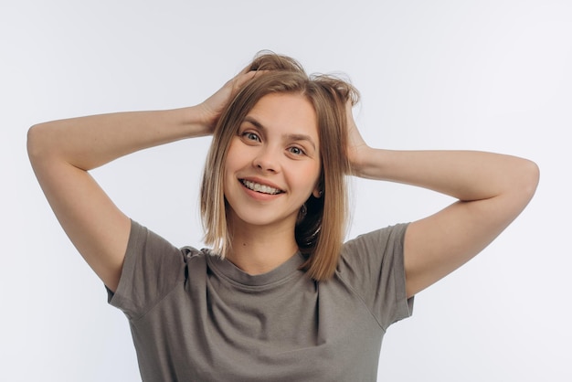 Portrait of a young beautiful girl with braces on a white background