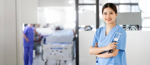 Portrait of young beautiful nurse with stethoscope standing at hospital