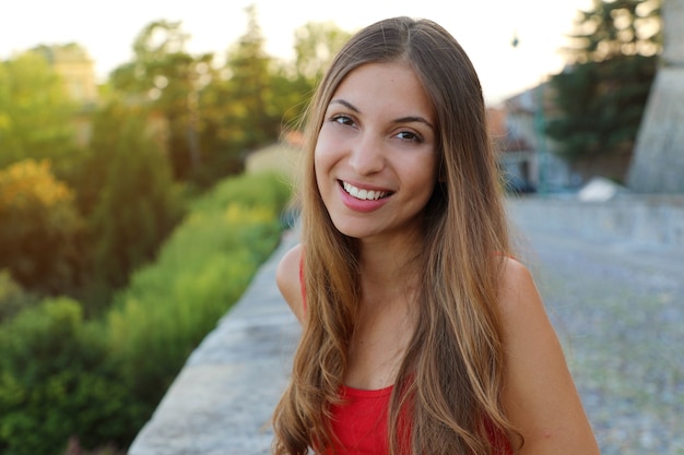 Portrait of young beautiful slim woman with red tank top