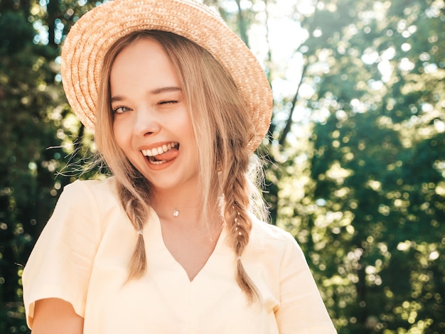 Portrait of young beautiful smiling hipster girl in trendy summer sundress