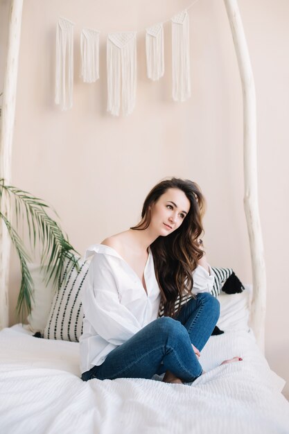 Portrait of a young beautiful woman in bed in the morning at home