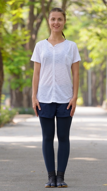 Portrait of young beautiful woman exercising at the park outdoors