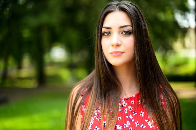 Portrait of a young beautiful woman outdoor in a park