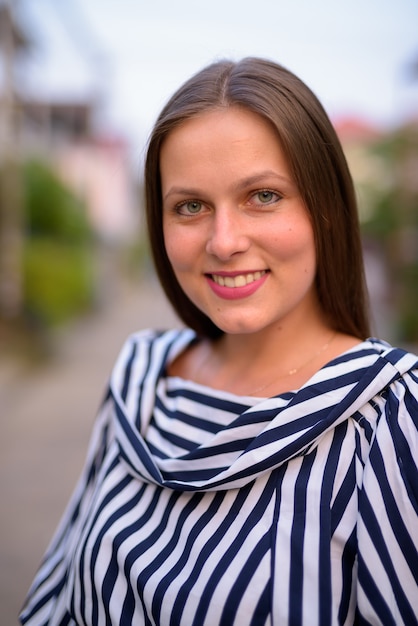 Portrait of young beautiful woman in the streets outdoors