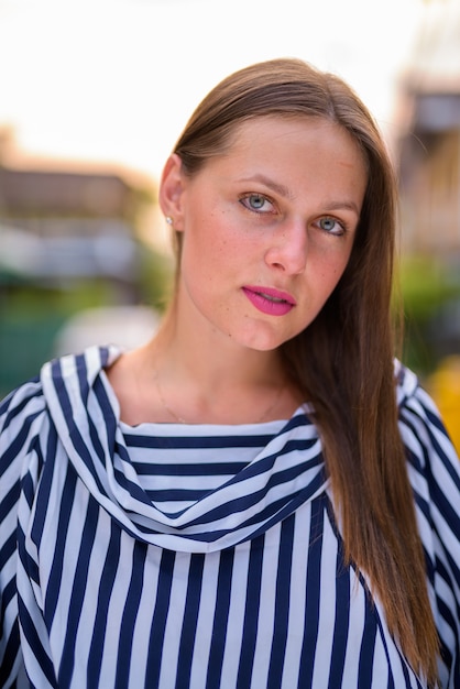 Portrait of young beautiful woman in the streets outdoors