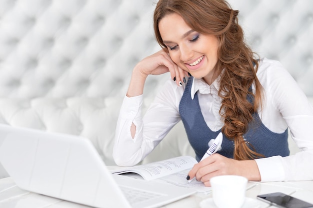 Portrait of a young beautiful woman using laptop